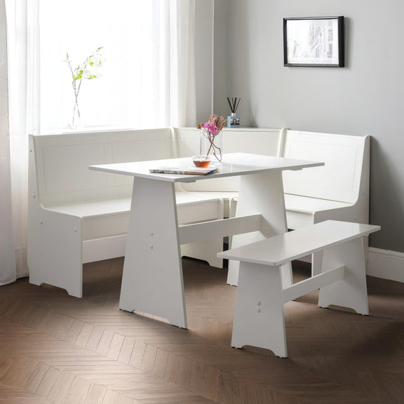 White dining set with table and benches in a room with curtains and a framed picture on the wall.