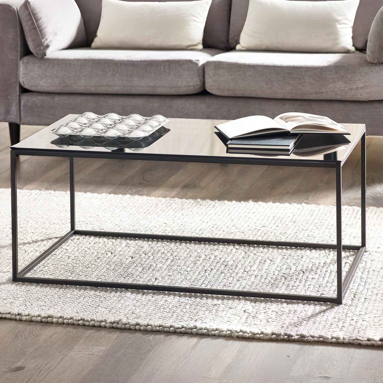 Coffee table with decorative items in a living room setting
