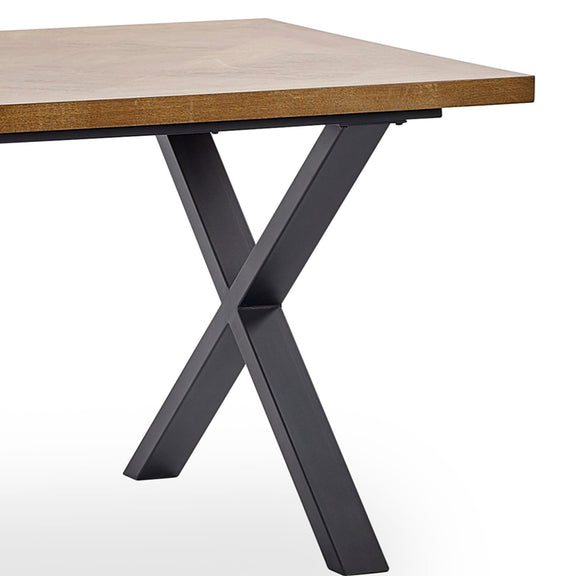 Table with wooden top and black metal legs on a white background