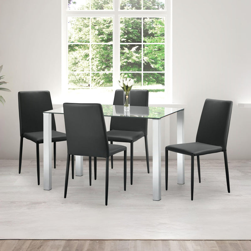 Dining room setup with a glass table and black chairs in a bright room.