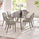 Dining table with six chairs in a bright room with large windows.