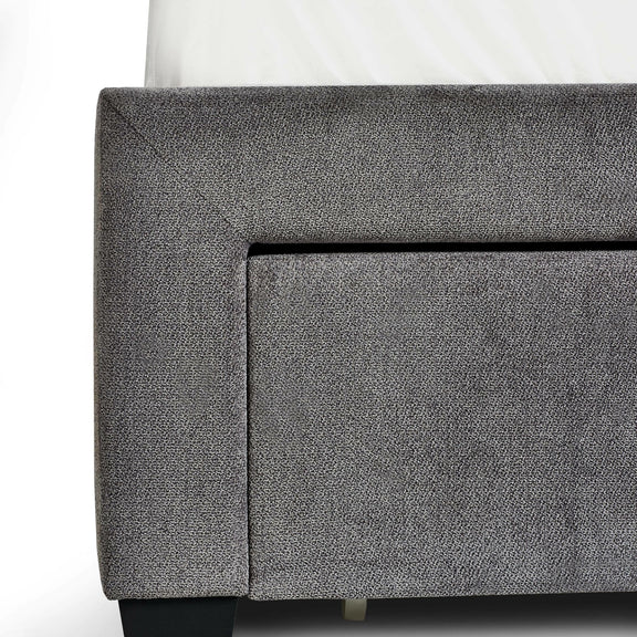 Gray upholstered corner of a piece of furniture on a white background