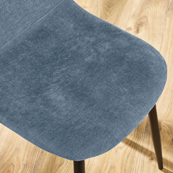 Close-up of a blue chair seat on a wooden floor