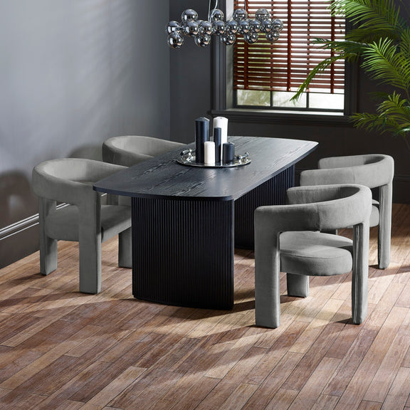Dining room with a dark wooden table and gray chairs on a wooden floor.