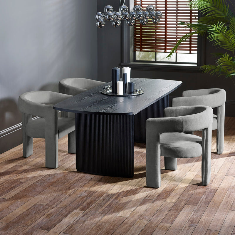 Dining room with a dark wooden table and gray chairs on a wooden floor.