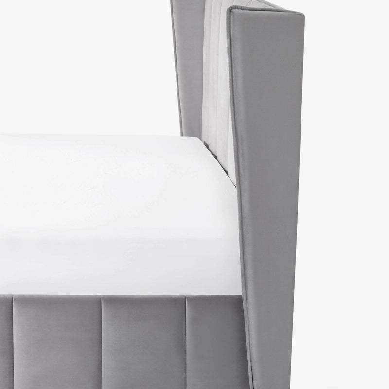 Gray upholstered chair with a white cushion on a white background