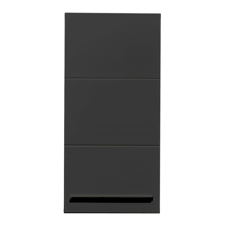 Black rectangular object wrapped in clear plastic on a cardboard surface