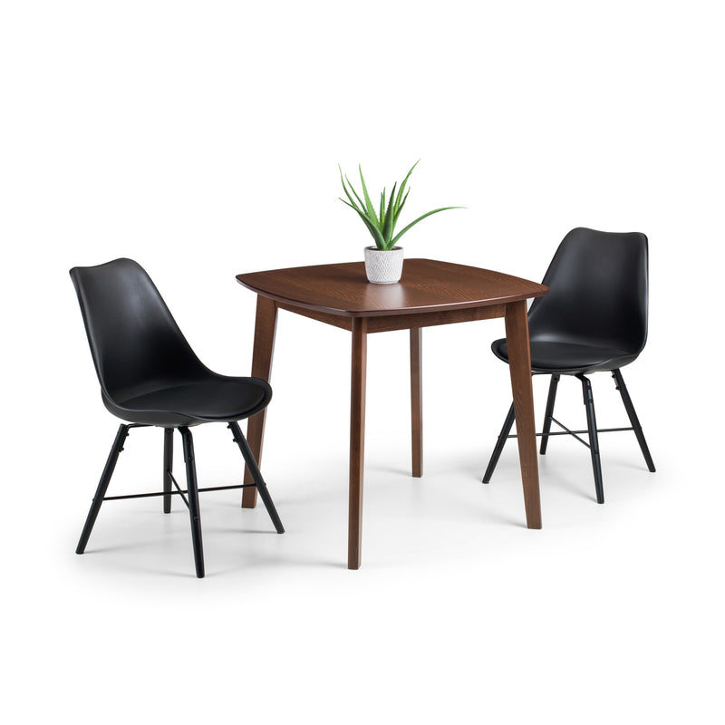 Dining table with two black chairs on a white background