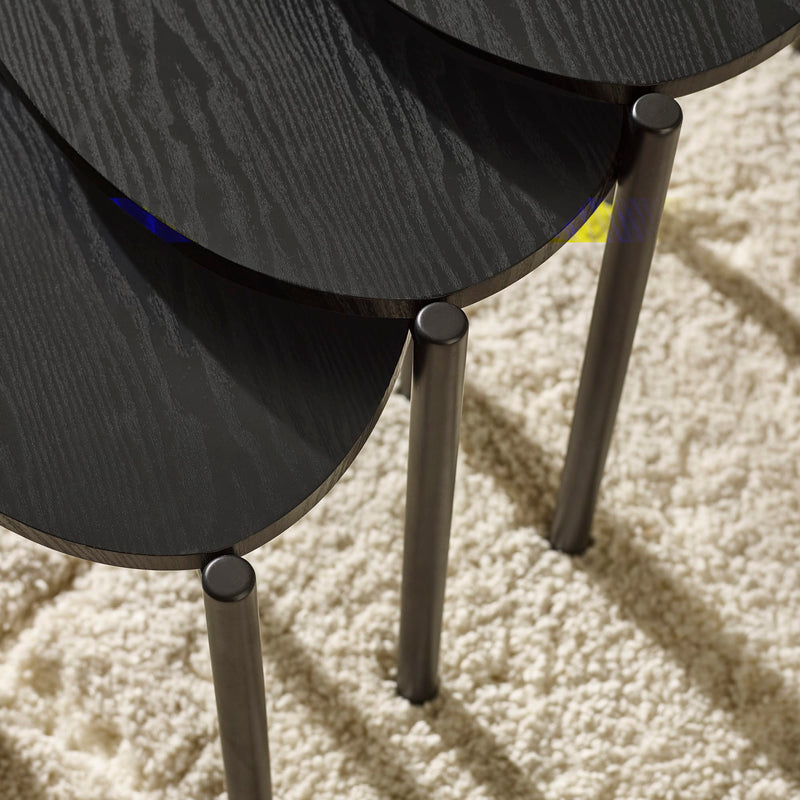 Stack of black chairs on a beige carpet