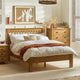 Wooden bed with white bedding and a side table in a bedroom setting.