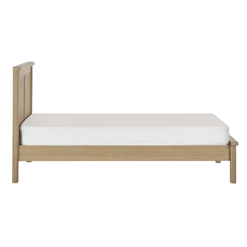 Wooden bed frame with a white mattress on a white background