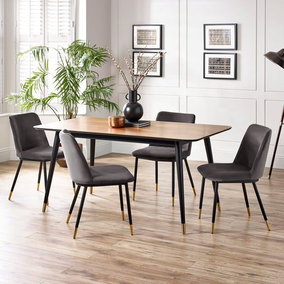 Dining room with a wooden table and gray chairs on a wooden floor.