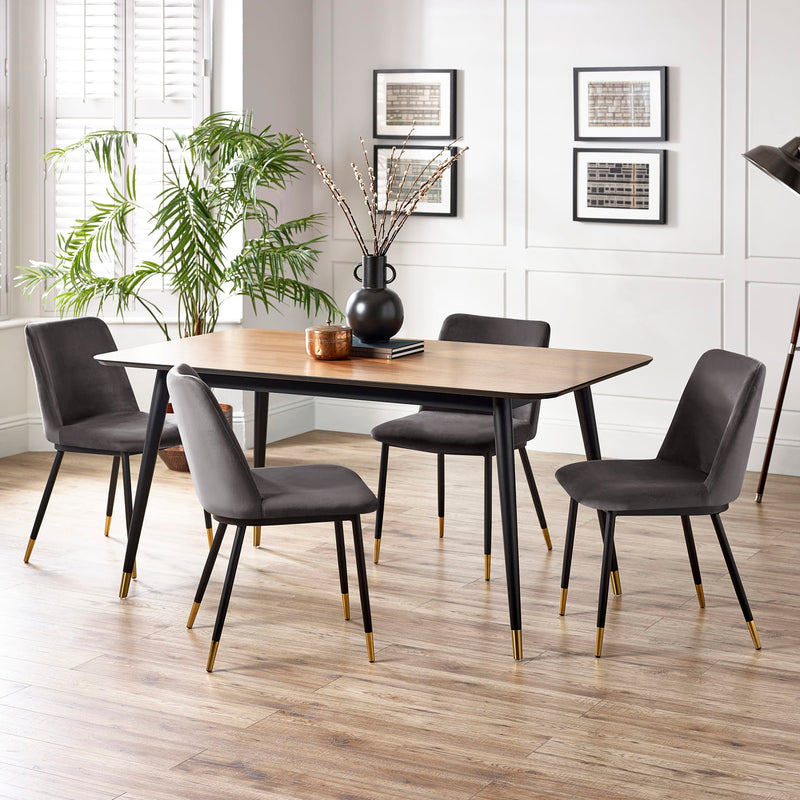 Dining room with a wooden table and gray chairs on a wooden floor.