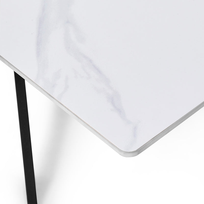 White tablecloth on a white table with a black leg