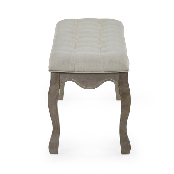 Stool with quilted beige top and wooden legs on a white background