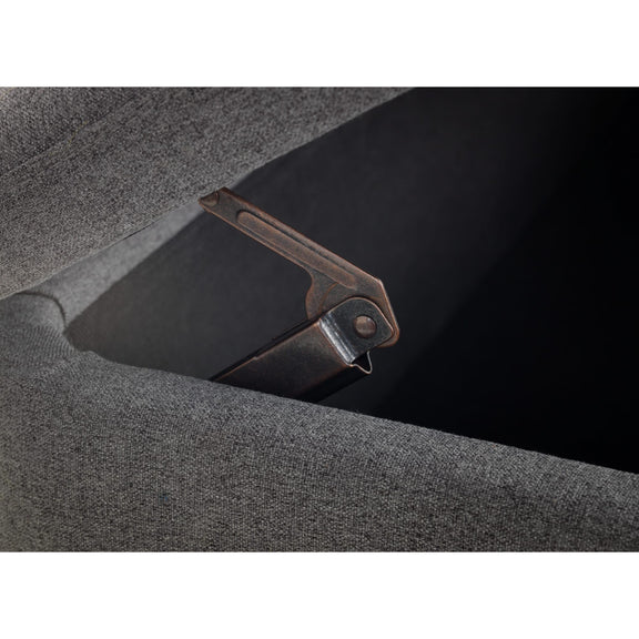 Close-up of a metal latch on a textured gray surface