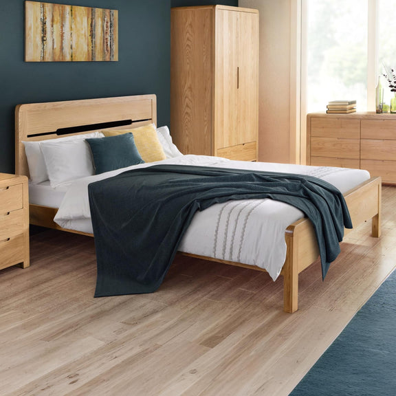 Wooden bed with bedding in a bedroom setting
