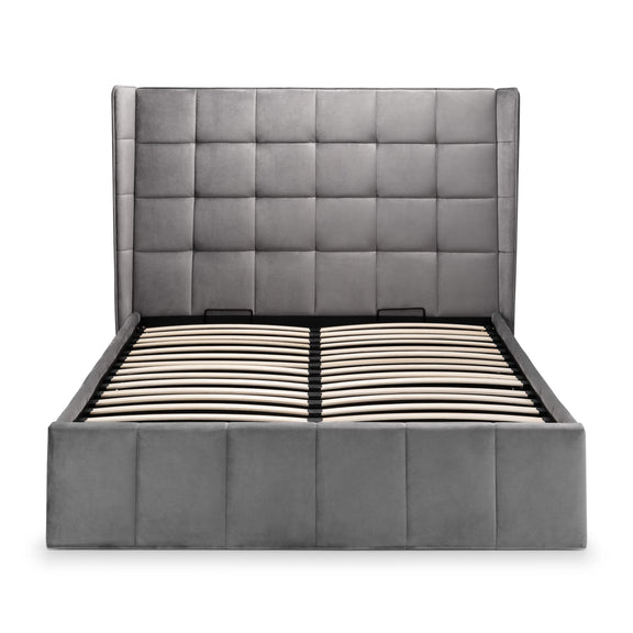 Gray upholstered bed with tufted headboard on a white background