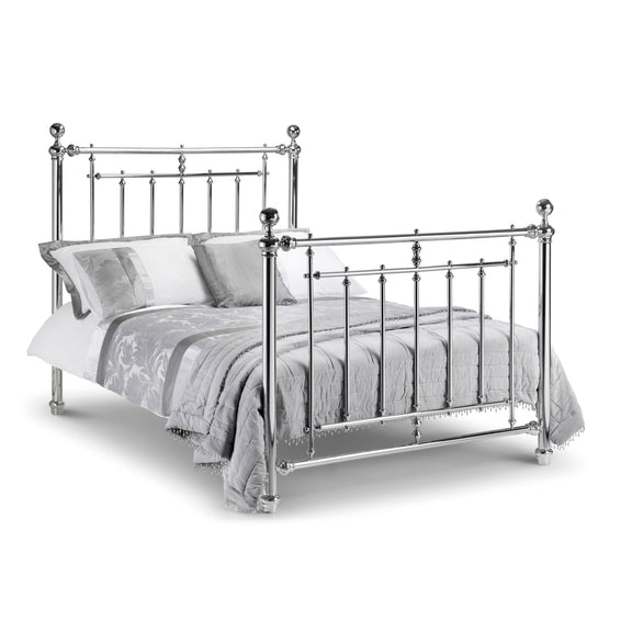 Silver metal bed with white bedding on a white background