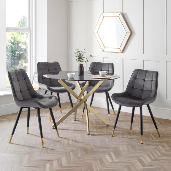 Dining room with gray chairs and a glass table.
