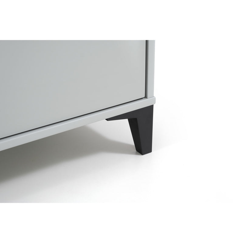 Close-up of a gray cabinet with a black leg on a white background