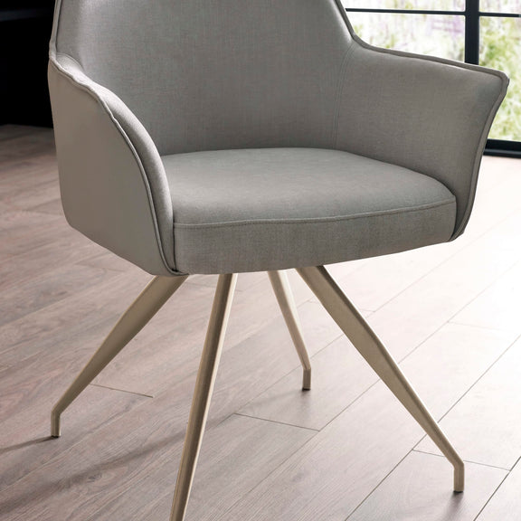 Gray armchair with beige legs on a wooden floor