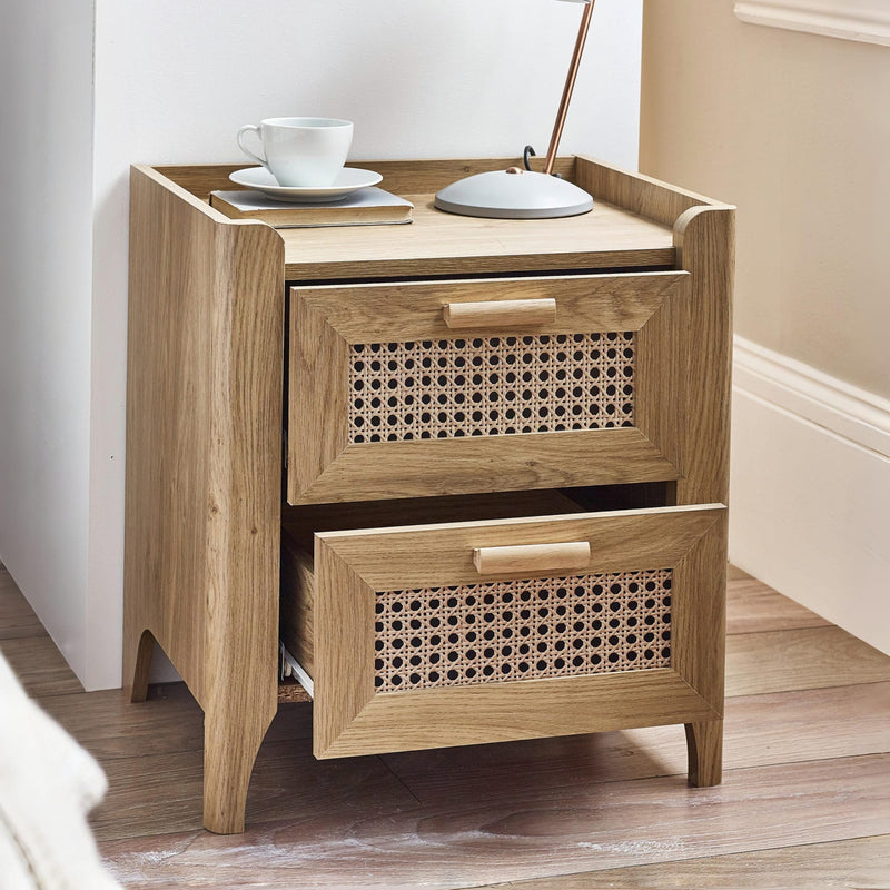 Modern oak bedside cabinet with woven rattan drawers in bedroom