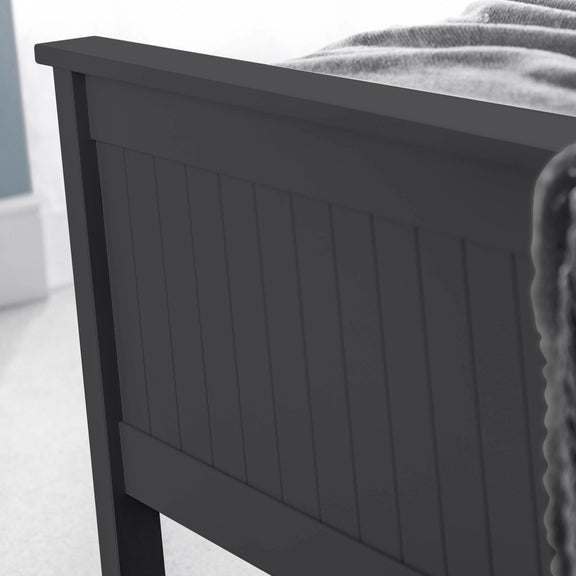 Dark gray wooden headboard on a bed with a white background