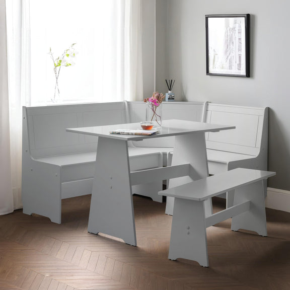 White dining set with bench seating in a room with a window and framed picture on the wall.