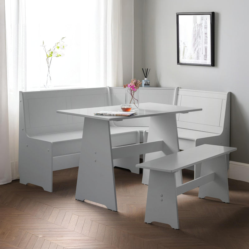 White dining set with bench seating in a room with a window and framed picture on the wall.