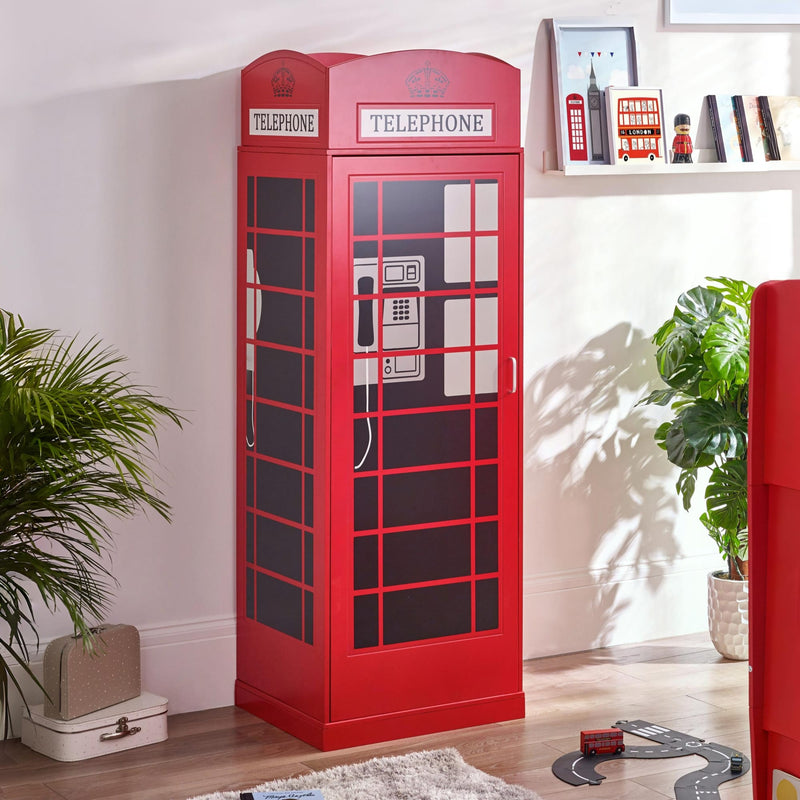Red telephone booth cabinet in a room with plants and decor