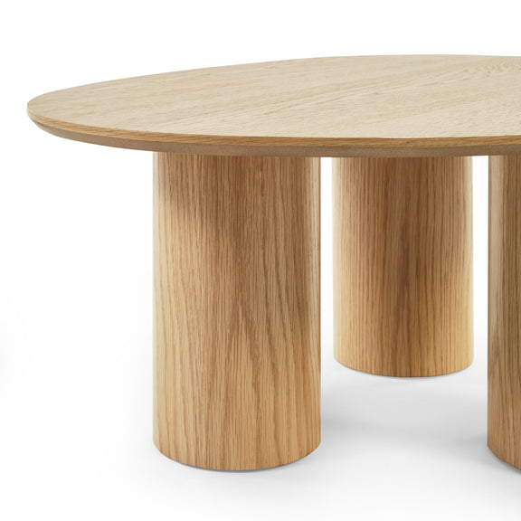 Wooden round table with four legs on a white background