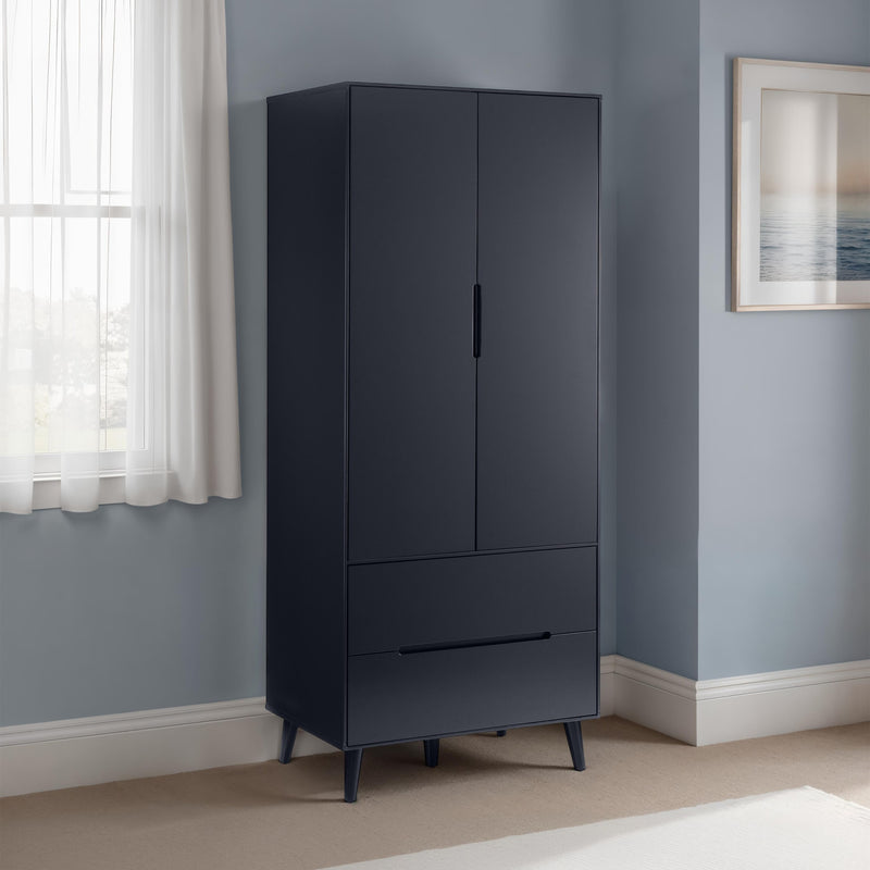 Black wardrobe with two doors and two drawers against a light blue wall.