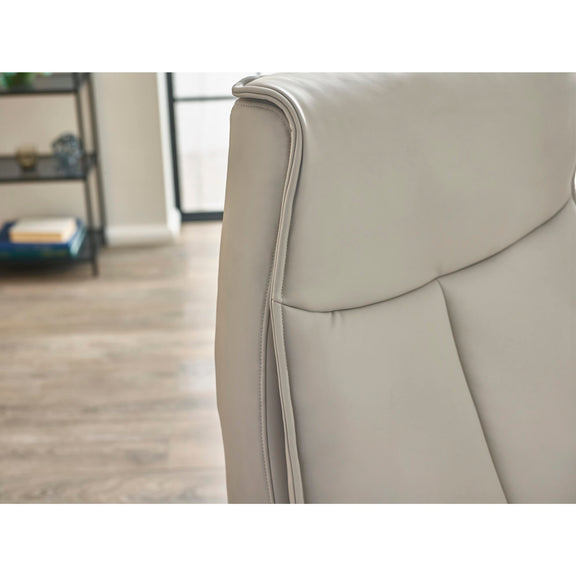 Gray armchair with a blurred background of a room.