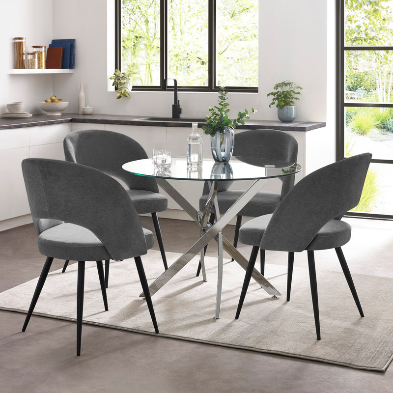 Dining room with a glass table and gray chairs in a modern kitchen.