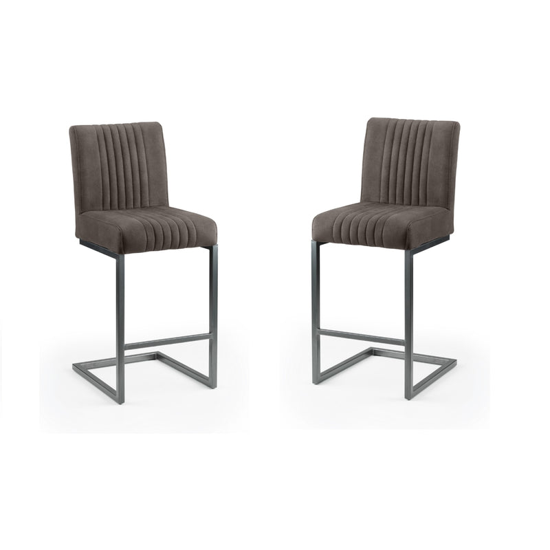 Two brown bar stools with pleated seats on a white background