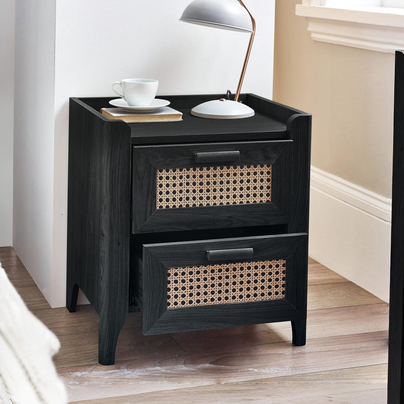 Modern black bedside cabinet with woven rattan drawers in bedroom