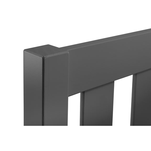 Close-up of a dark gray metal railing on a white background