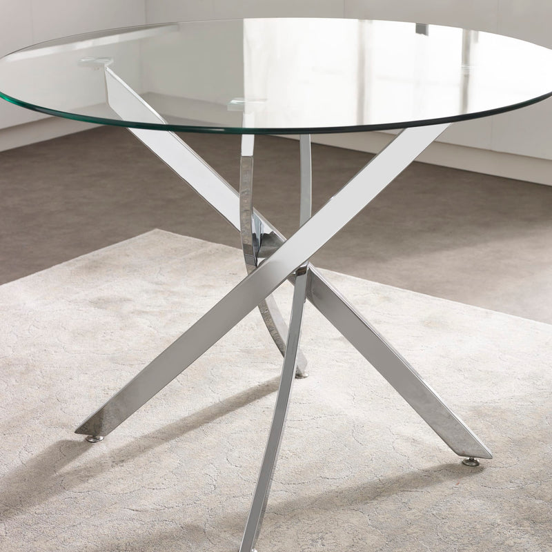 Modern glass dining table with metal legs on a neutral floor.