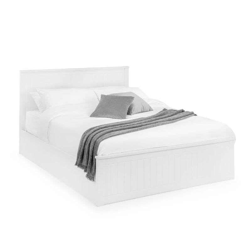 White bed with gray bedding on a white background