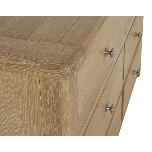 Wooden furniture with a corner view showing a drawer and cabinet.
