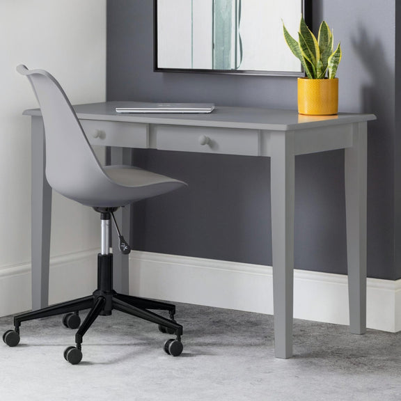 Gray desk with a chair and a plant in a yellow pot against a gray wall.