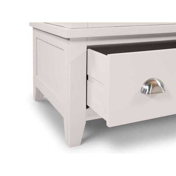 Light gray wooden drawer with a metallic handle on a white background