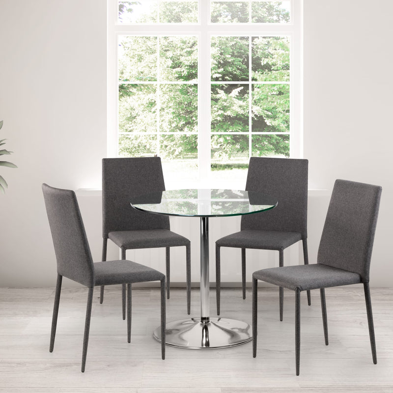 Dining set with a round glass table and four gray chairs in a bright room.