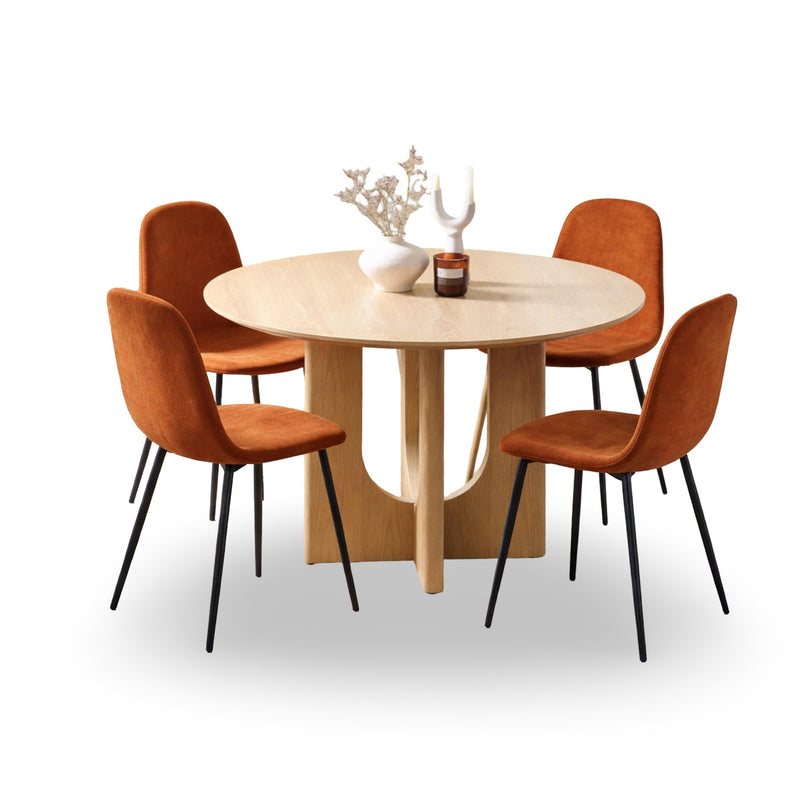 Round dining table with four orange chairs on a white background