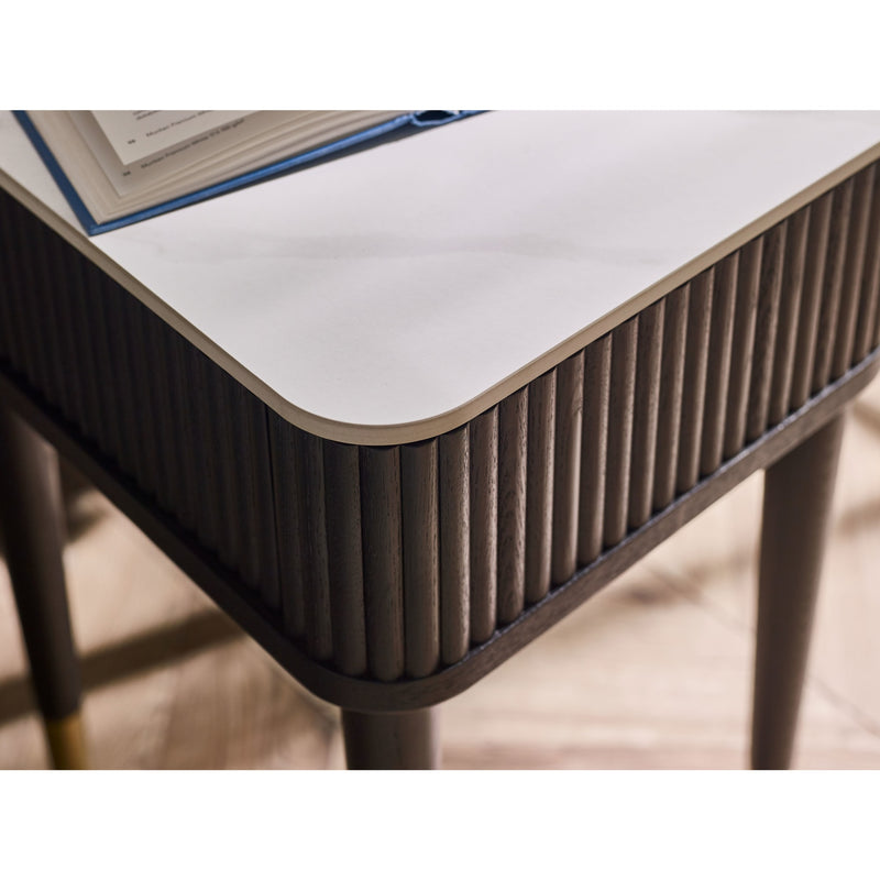 Close-up of a modern table with a textured surface and white top.