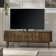Large flat-screen TV on a wooden stand in a living room setting.