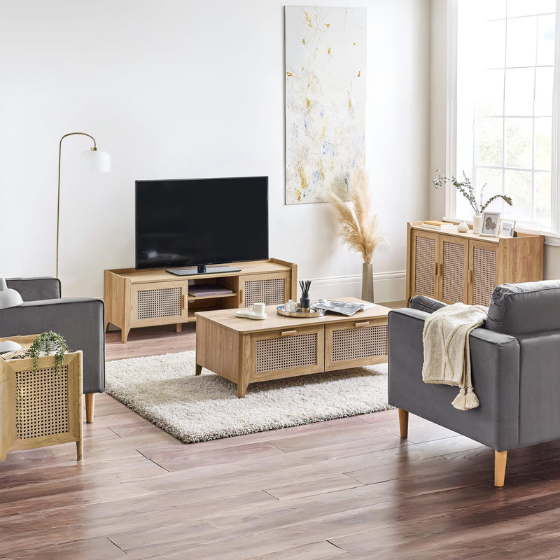 Modern living room with gray sofa, wooden coffee table, and TV stand.