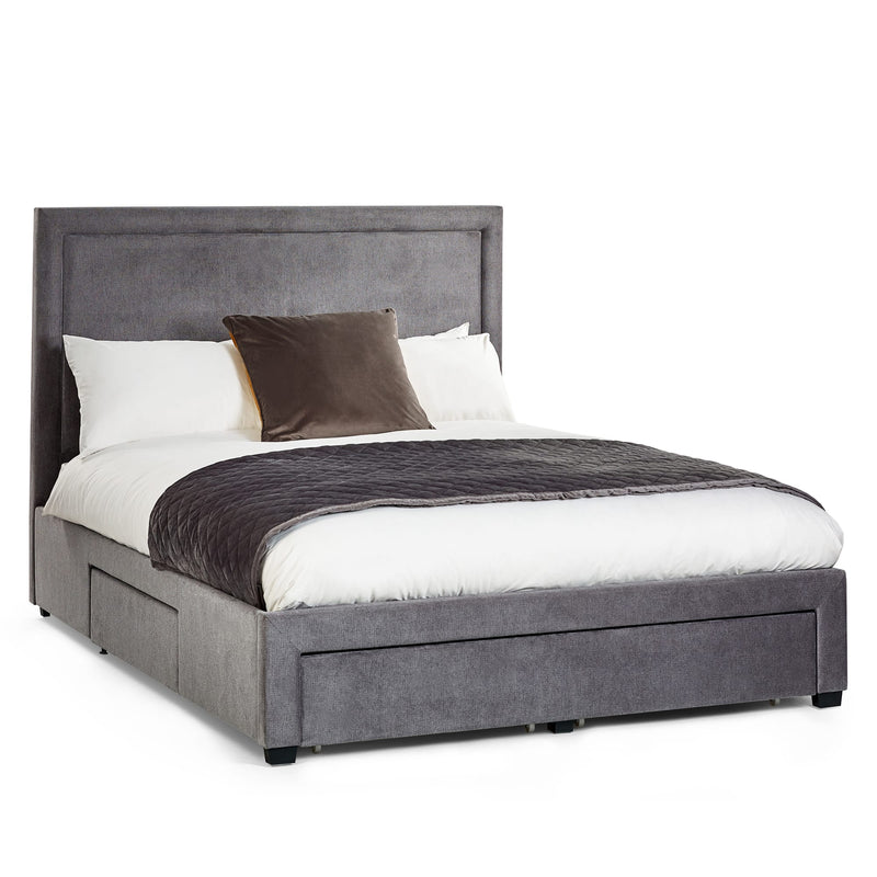 Gray upholstered bed with white bedding and a brown pillow on a white background