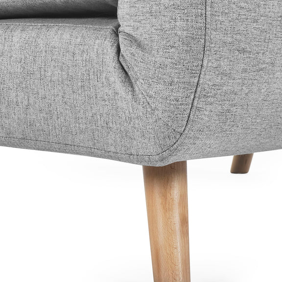 Gray upholstered chair with wooden legs on a white background
